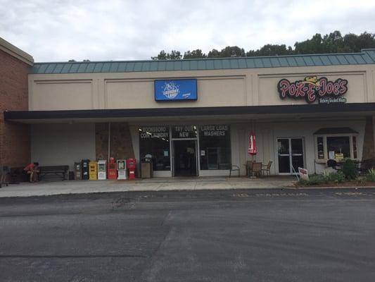 Laundry land is located between food lion and Pok e joes in the shopping center behind Starbucks.