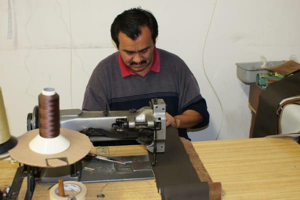 Upholsterer working at Pacific Palisades Upholstery Shop.