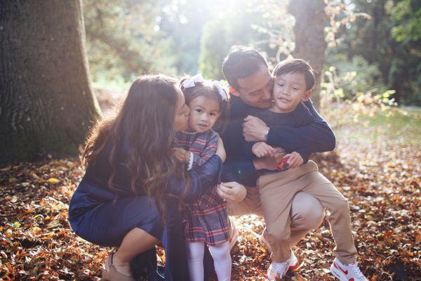 A mother and father hug their daughter and son at their family photo session