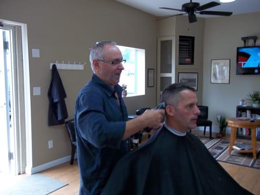 Master Barber, Owner Paul giving a client a haircut.