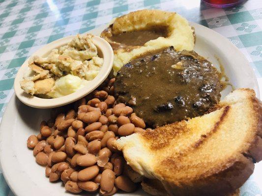 Hamburger steak, pinto beans, banana pudding, mashed potatoes and gravy