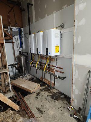 installed new commercial tankless water heaters, redirected floor drains, and built new wall.