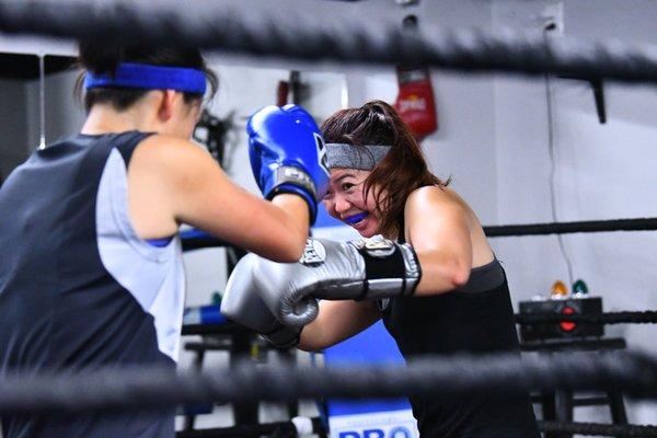 Women sparring in the boxing ring