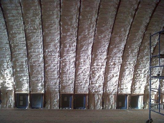 Walls of a semi-circle shaped pole barn.