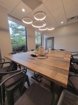 Conference room that seats up to 12, has a tv to connect computer, and zoom technology for online meetings.