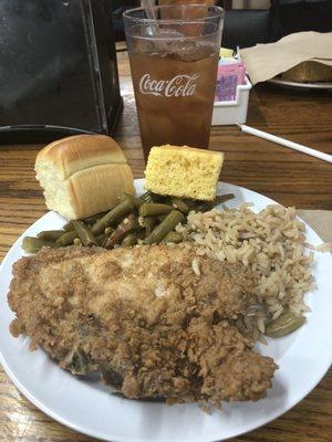 Fried pork chop, greens, rice, roll, corn bread and sweet tea