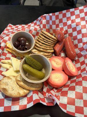 Cheese plate with pickled eggs and sausage