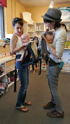 A client at Mondays Babywearing Cafe gets help with their ErgoBaby carrier.