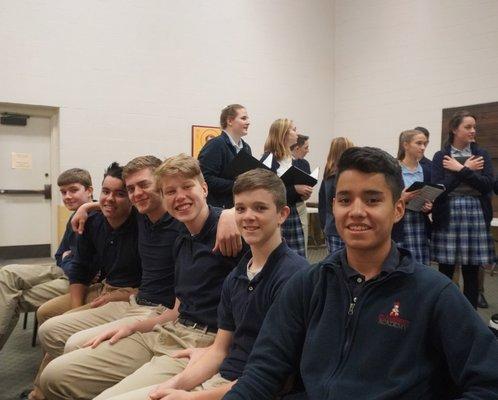 Senior High boys awaiting a school assembly