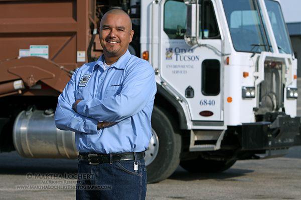 Advertising/ PR photo: COT Environmental Services employee by the sanitation truck he drives.