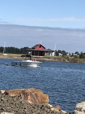 9/25/21 A boat passes by the abandoned cottage frequently photographed and the subject of many artists paintings.