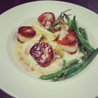 Pan seared scallops served with asparagus, pancetta, and a white wine pan sauce with garlic mashed potatoes