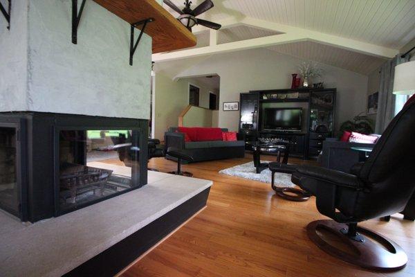 The main living room at Grumpsters House features a three-sided gas fireplace.