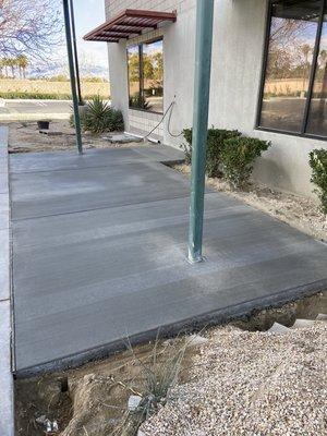 We relocated this steel structure and then poured a concrete pad for their new office patio.