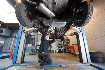 A close up of one of our mechanics performing an under car repair.