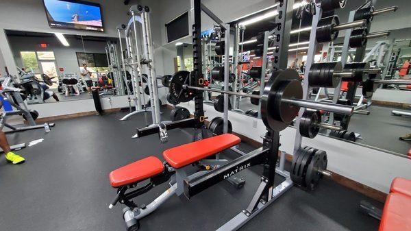 One power rack and Smith machine. No dedicated flat or incline bench press but the lone power rack can convert as needed.