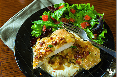 Marinated chicken breasts drizzled with lite ranch, topped with bacon, melted cheese, and served with a side of mashed potatoes.