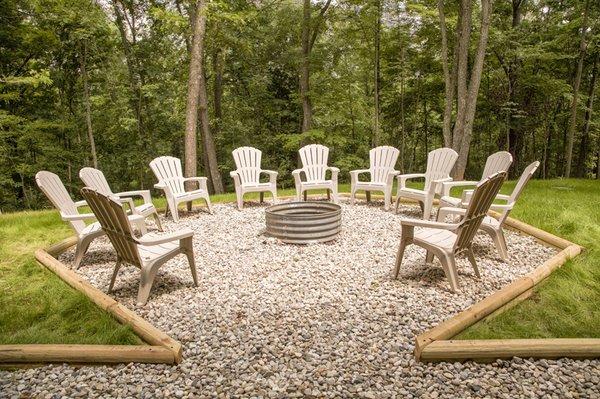 Fire pit area overlooking a wooded ravine.