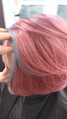 Vivid coral - blue hair color and a short bob haircut.