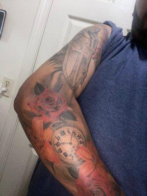 Saint Michael and a set a roses and Lily's with a clock by James Flores