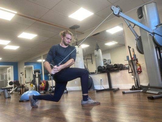 Balance + Core. 
This full body functional exercise is an alternating lunge with cable twist.