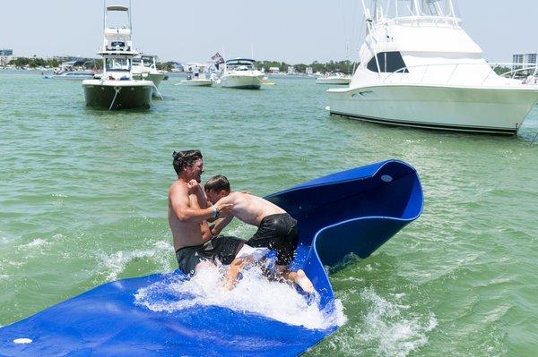 These boys are playing "King Of The Hill" on the lily pad!