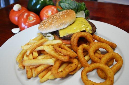 Cheese Burger with onion rings and fries