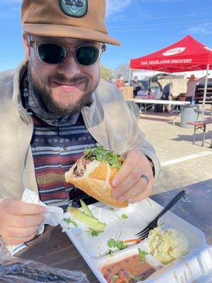 Happy man eating BBQ Banh Mi