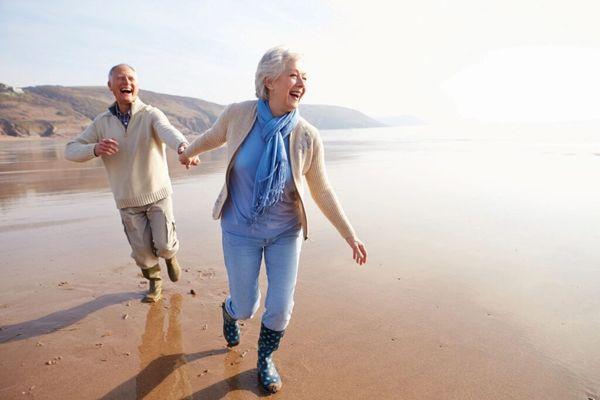 Happy couple strolling on beach