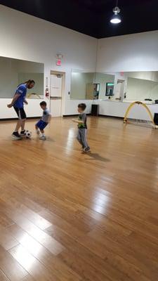 The children interact with each other and Coach Nathan. Learning to share and take turns.