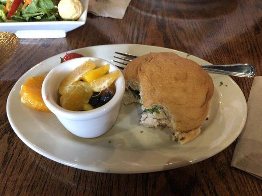 Delicious chicken salad on a grilled brioche bun and fruit salad.