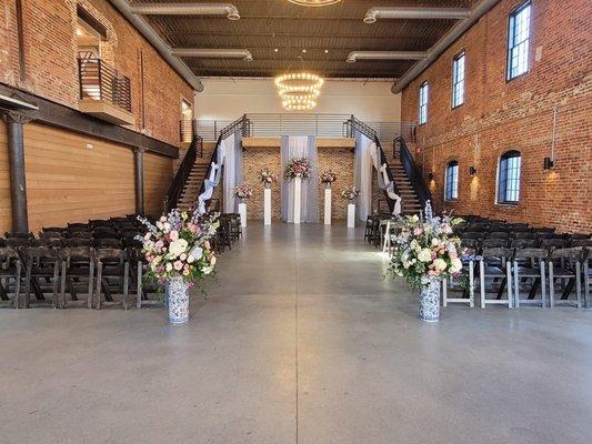 Ceremony with drapes, columns and florals