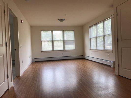 Brightly lit living area with 2nd floor corner unit.