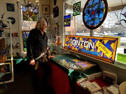 Francis Denning, owner, artist. Looking out the front window.  The sign will be house at Tointon Gallery in Greeley.