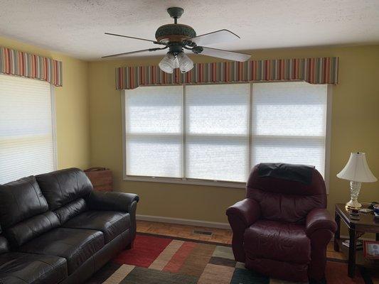 Fabric wrapped cornices in a cheery pattern brighten this Utica home