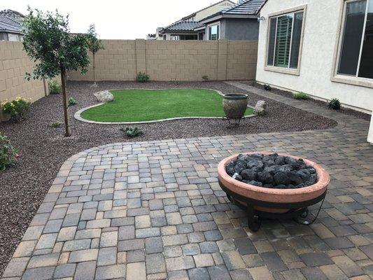 Another custom back yard. Fire bowl Fire feature, artificial turf, pavers, rock and plants.