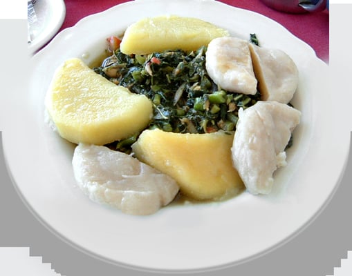 Callaloo and saltfish With boiled dumplings and yellow yam.