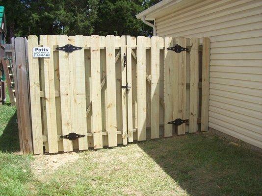 Custom wood, shadow-box privacy fence.