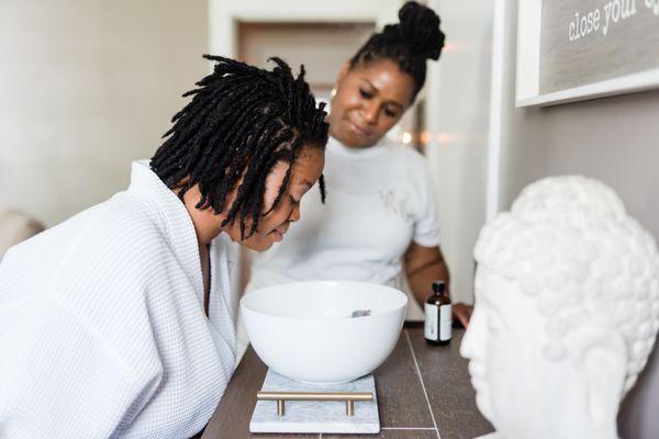 OMG founder, Shayla supports a client during an aromatherapy session   utilizing a custom blend of essential oils.