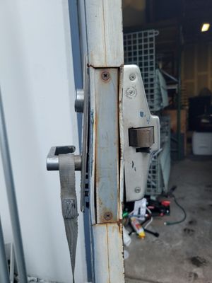 Emergency exit device repair on a Old door That should have been replaced a long long time ago