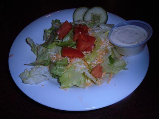 Dinner salad with a side of dressing.