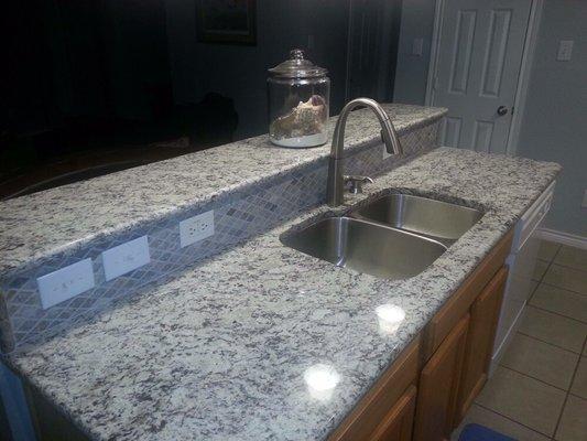 New granite with natural stone back splash