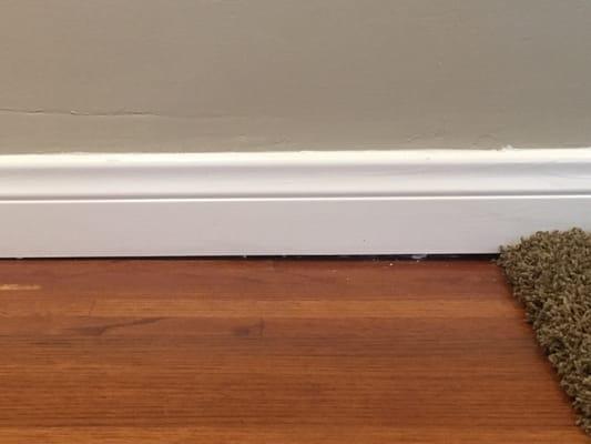 1/4" gap left from baseboard install as it transitions from wood to carpet