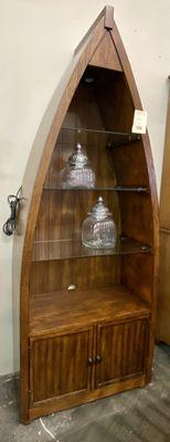 Boat shaped lighted wall unit with glass shelves