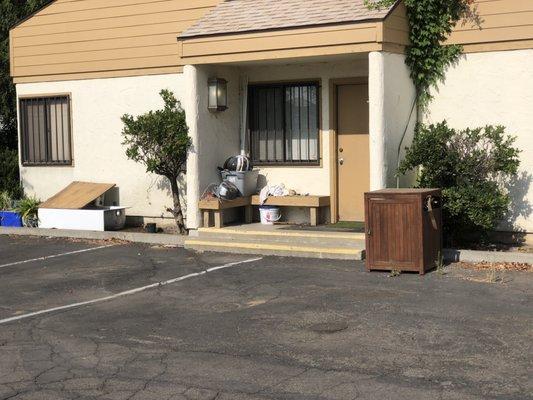 Trash-strewn outbuilding behind the one where our rooms were, but within the gated compound.