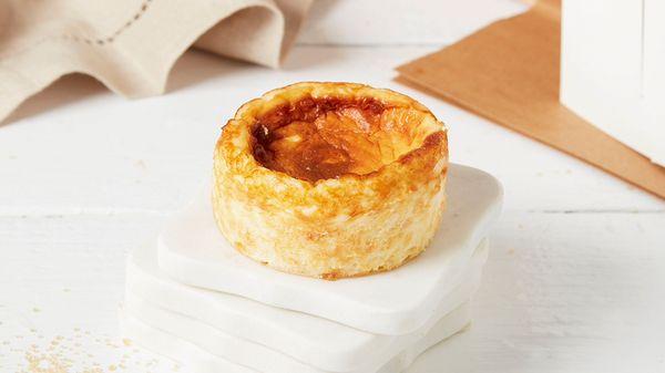 Soufflé'd cheesecake forming a caramelized exterior, serving as a natural crust, with a creamy interior and notes of wood fire