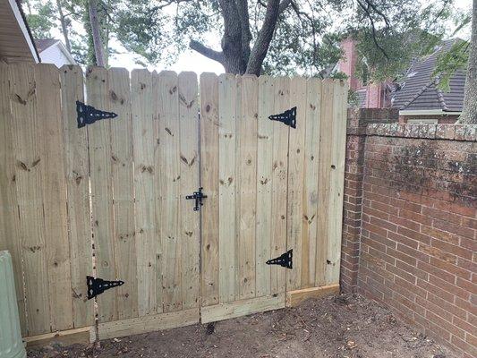 Fence/gate made out of treated pine with a metal frame