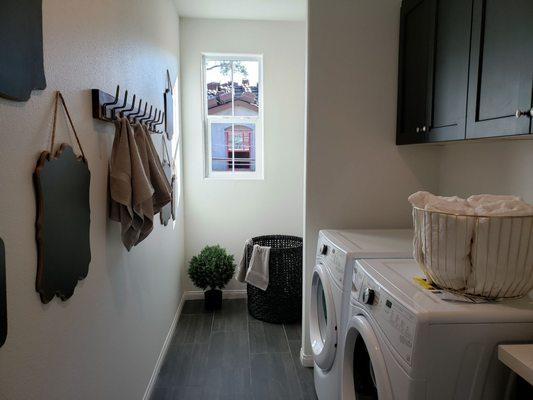 Extra large laundry room with linen closet space at the far end.