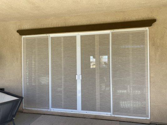 French doors with solar screen to block out the sun.