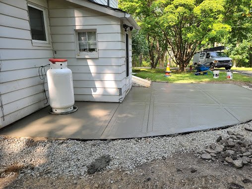 Concrete patio before Blacktop driveway